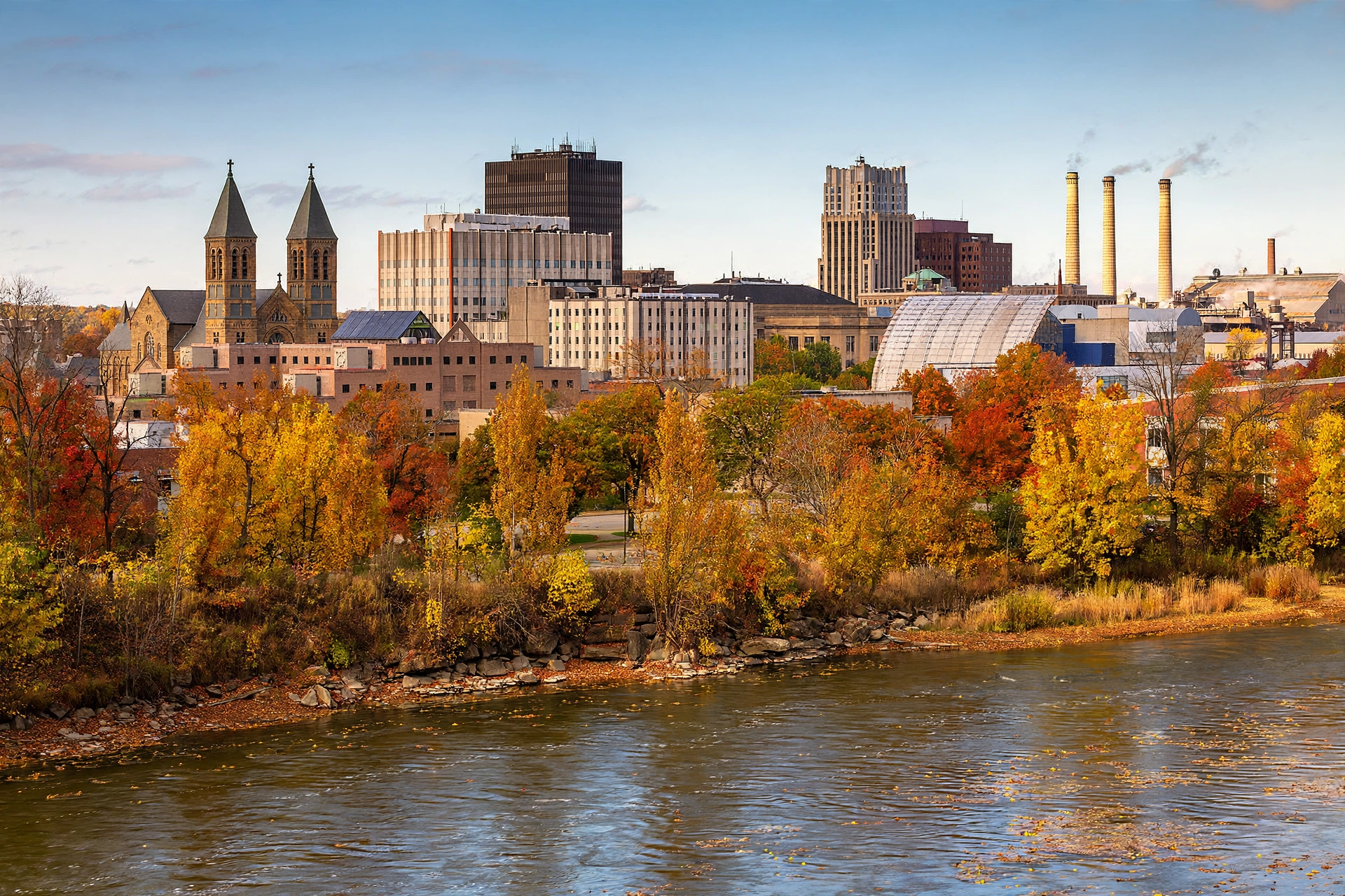 Downtown Akron skyline with the Cuyahoga River in the foreground on an autumn afternoon