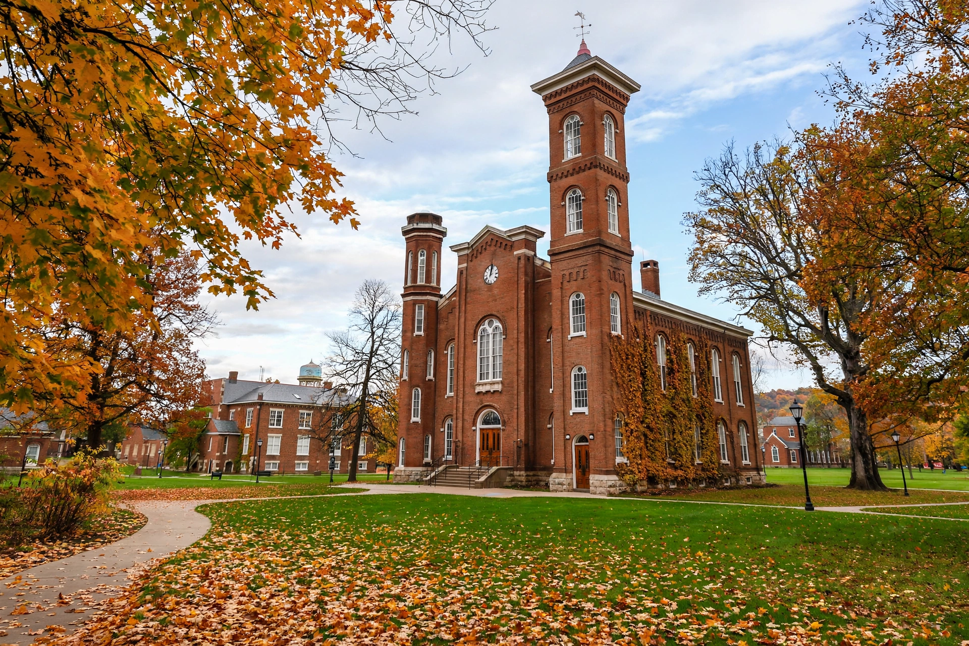 Historic brick academic building with clock tower and green lawn on a small university campus in Ashland, Ohio