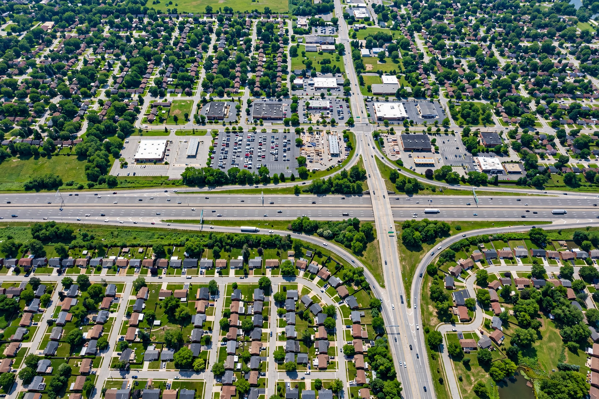 Interstate highway corridor with commercial development and brick ranch neighborhoods in an Ohio suburb