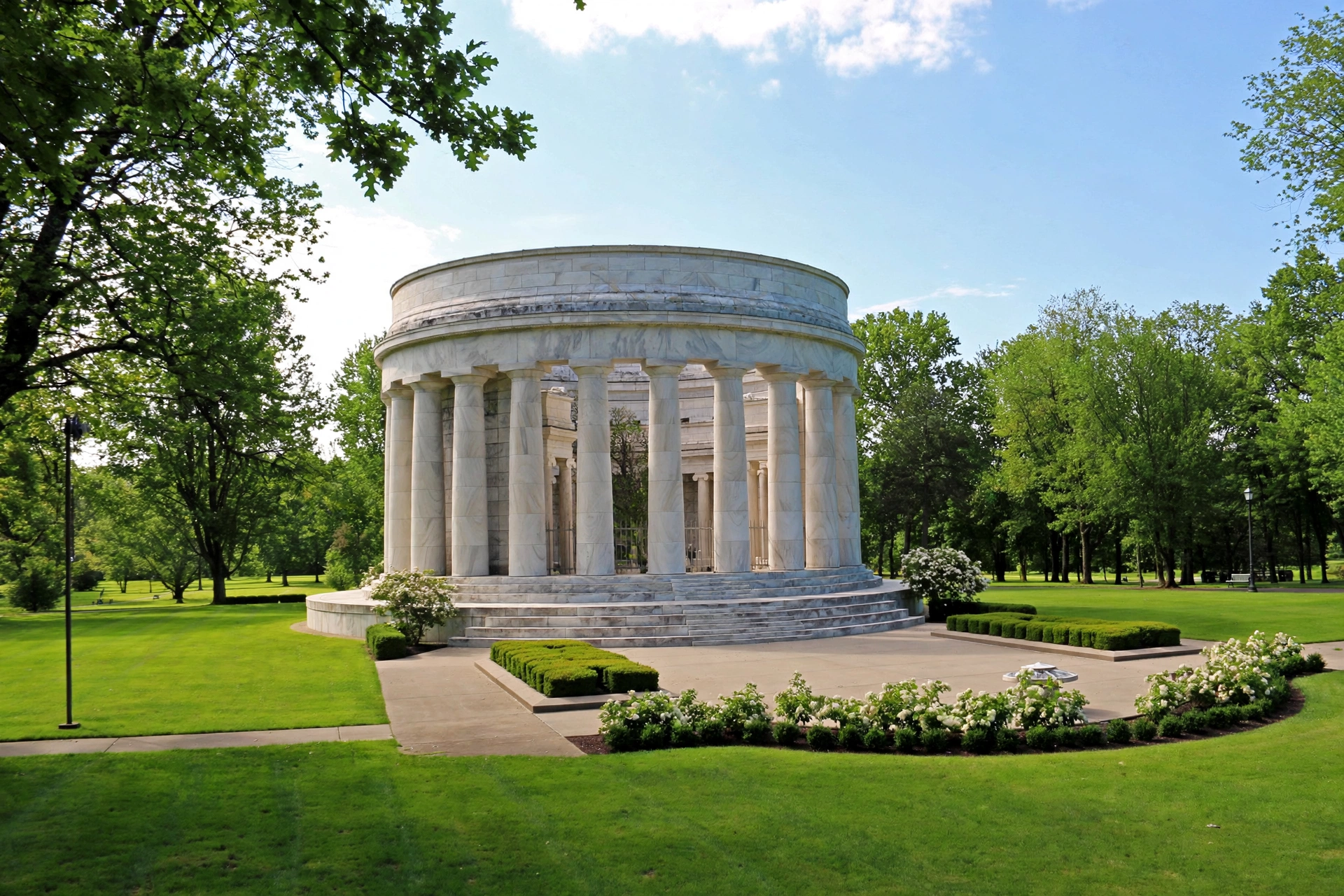 Grand circular stone memorial monument surrounded by manicured lawns in Marion, Ohio