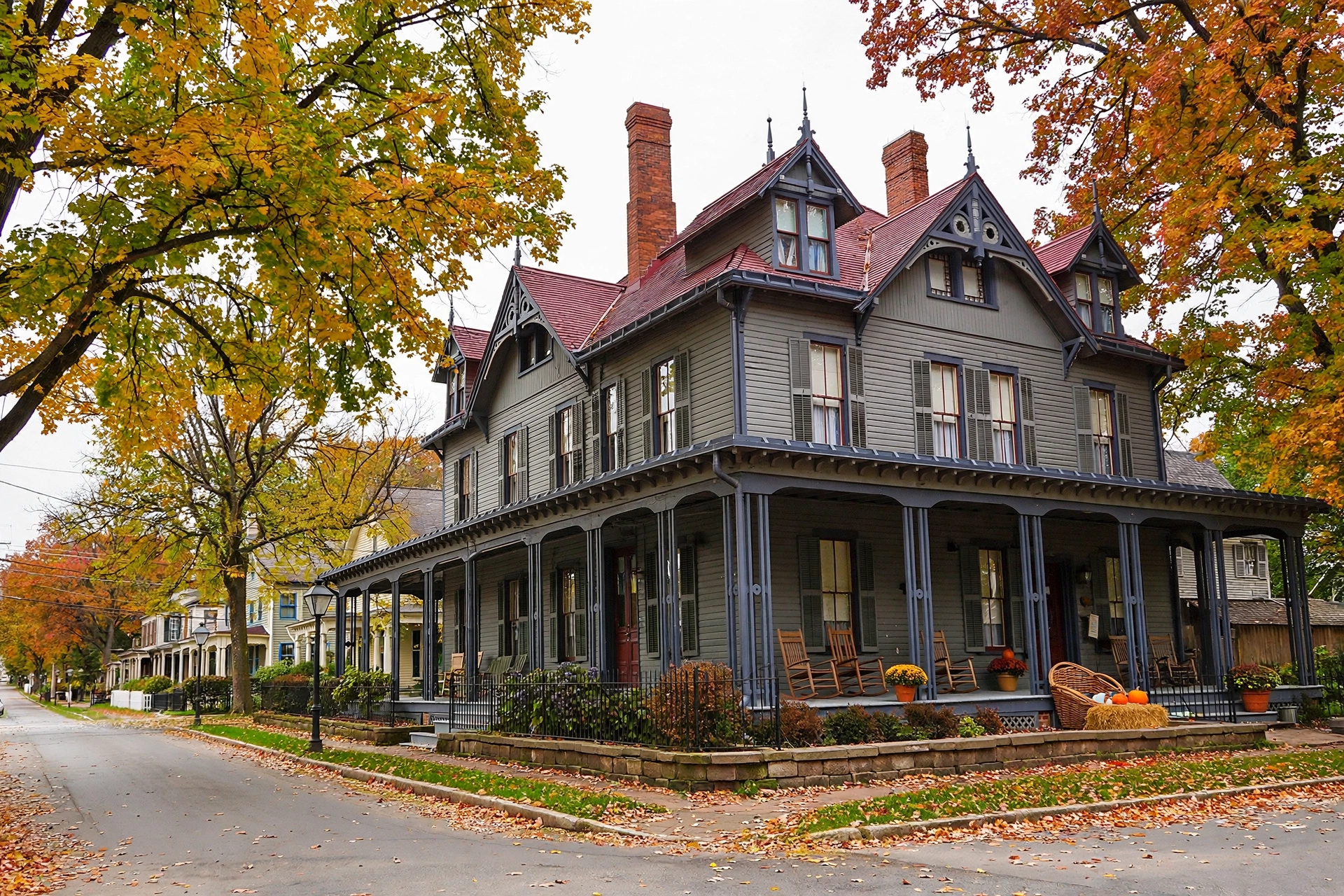 Historic 19th century farmhouse with a wraparound porch on a tree-lined street in Mentor, Ohio, similar to the James A. Garfield National Historic Site area