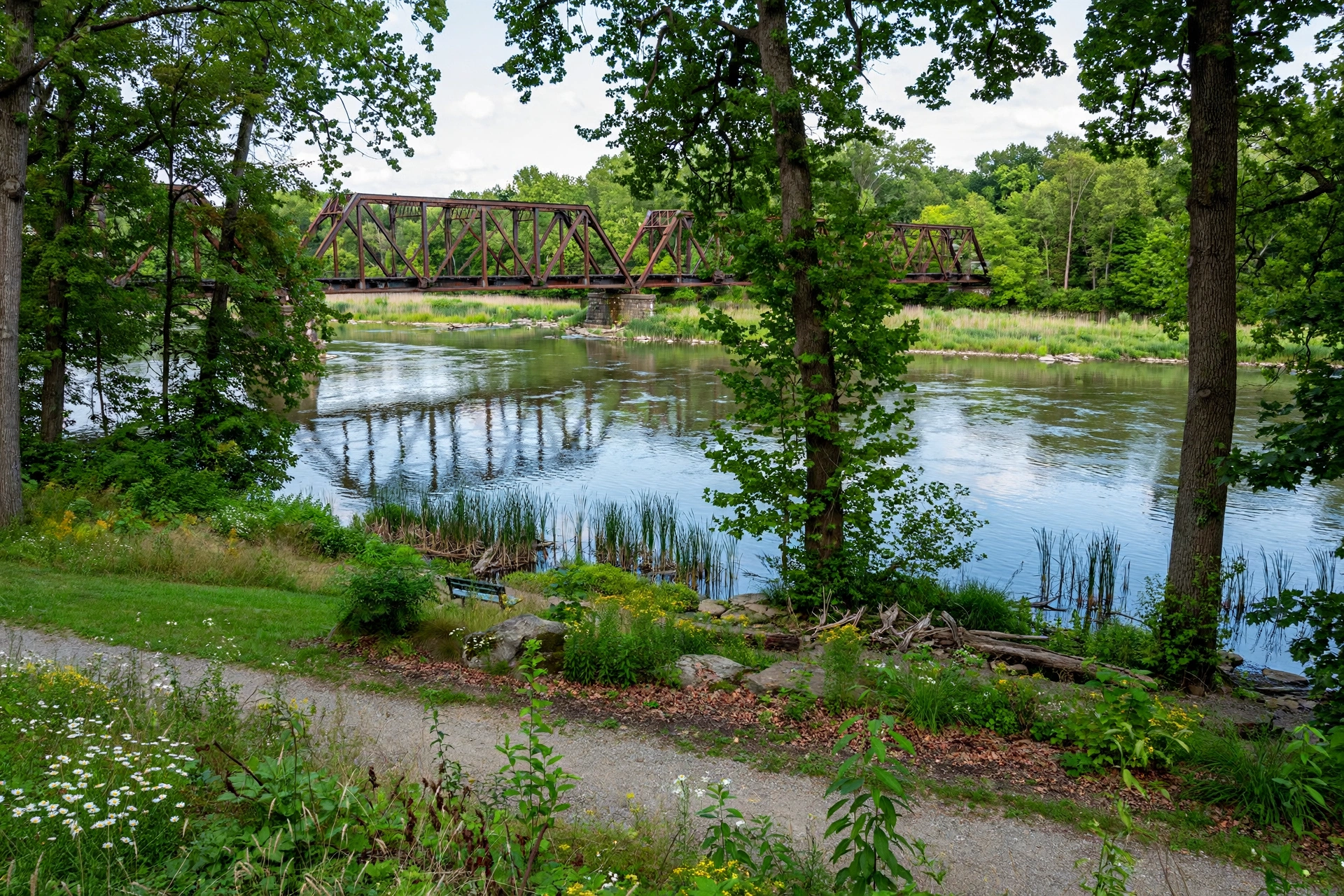 The Great Miami River flowing through a riverside park in Middletown Ohio with a historic bridge
